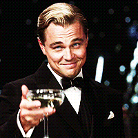Leonardo DiCaprio raising a glass in congratulations